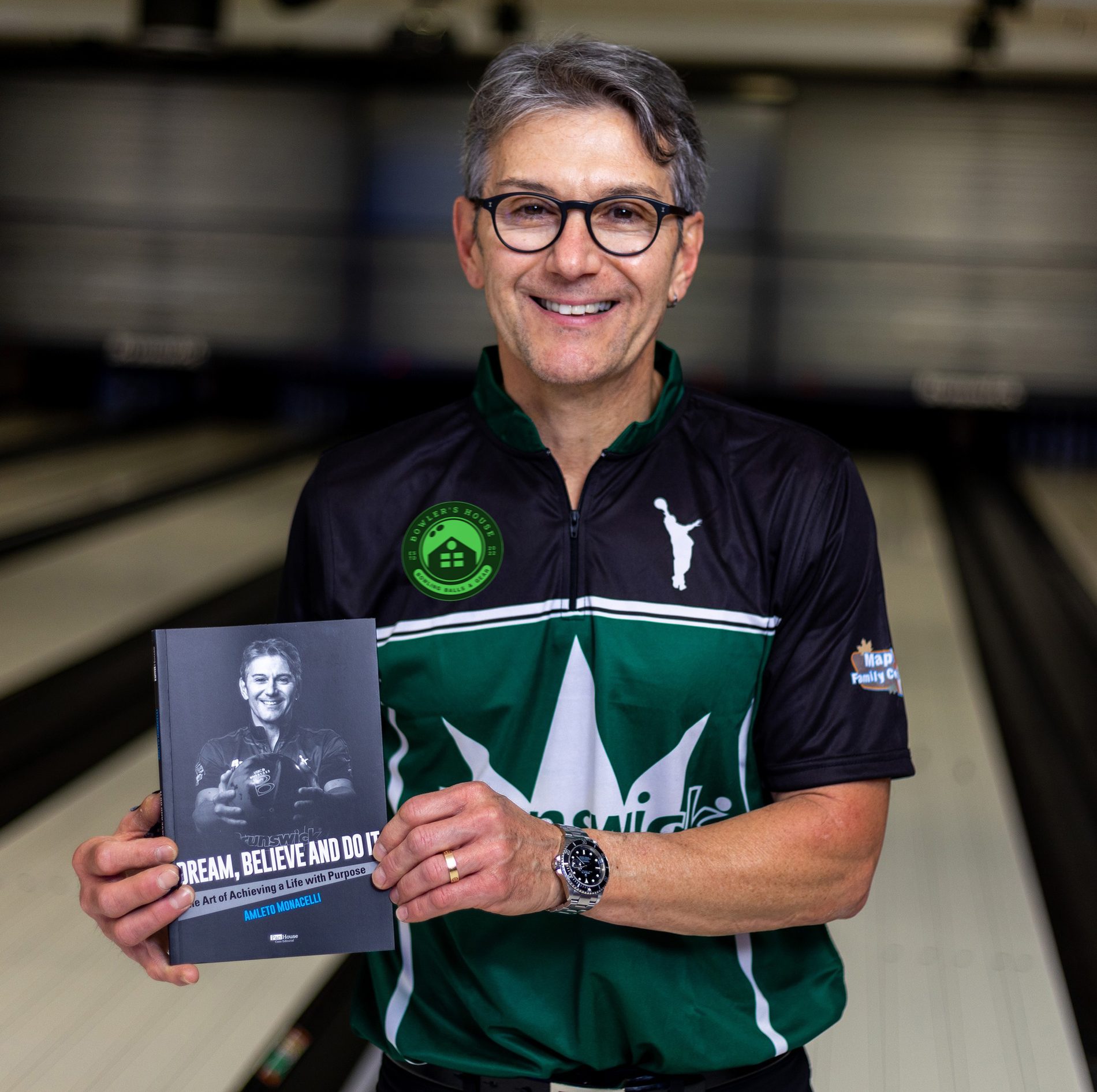 Amleto Monacelli holding his published autobiography