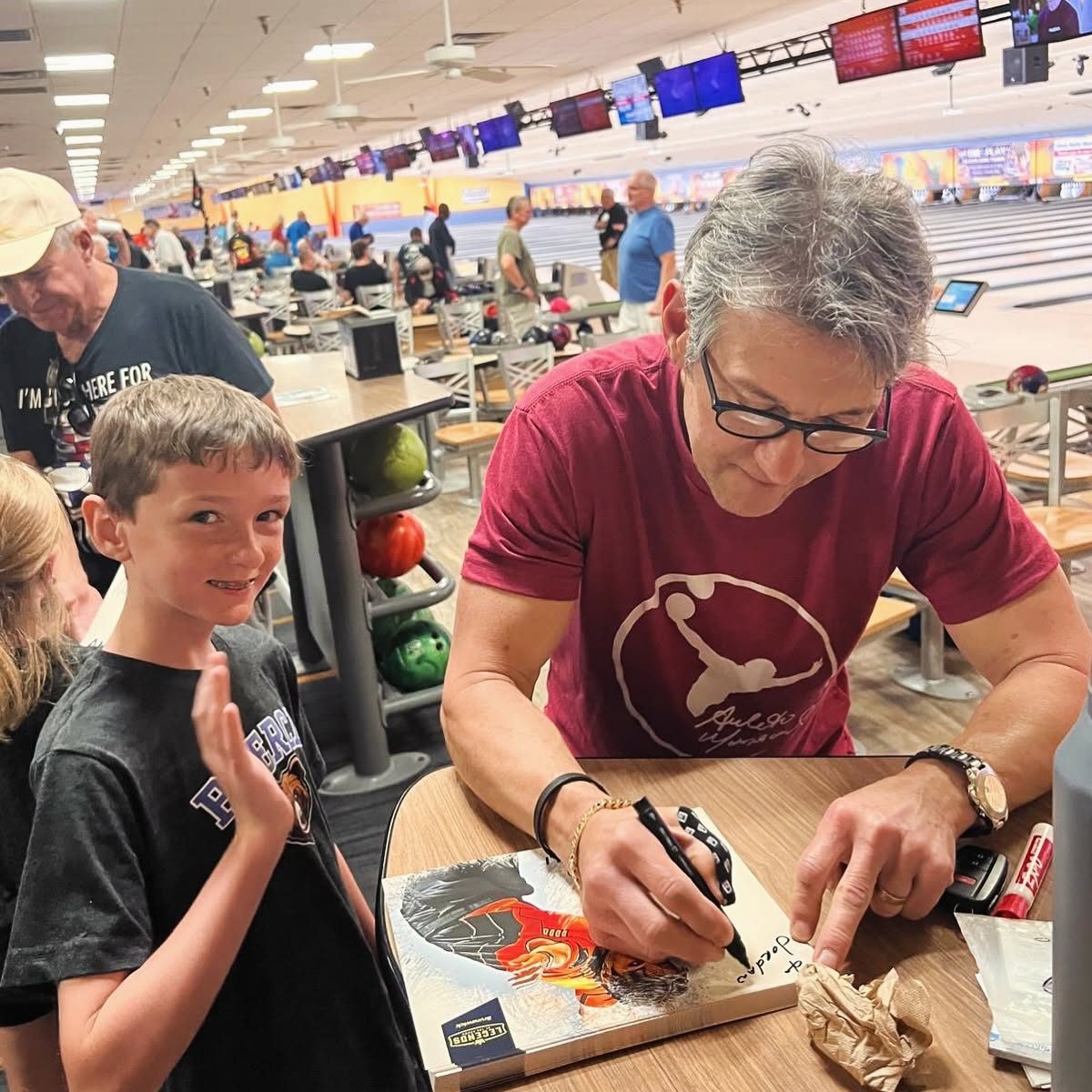 Amleto Monacelli signing an autograph for a young fan